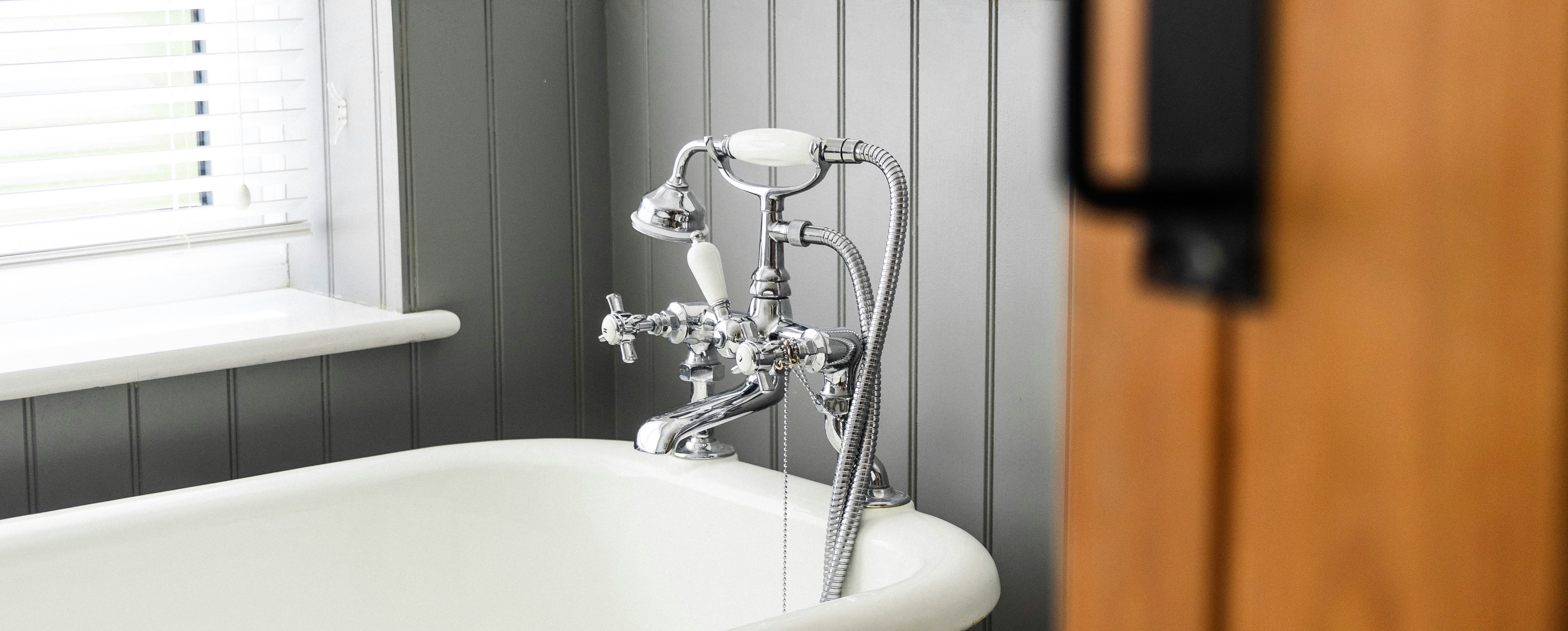 Chrome bath taps with shower attachment