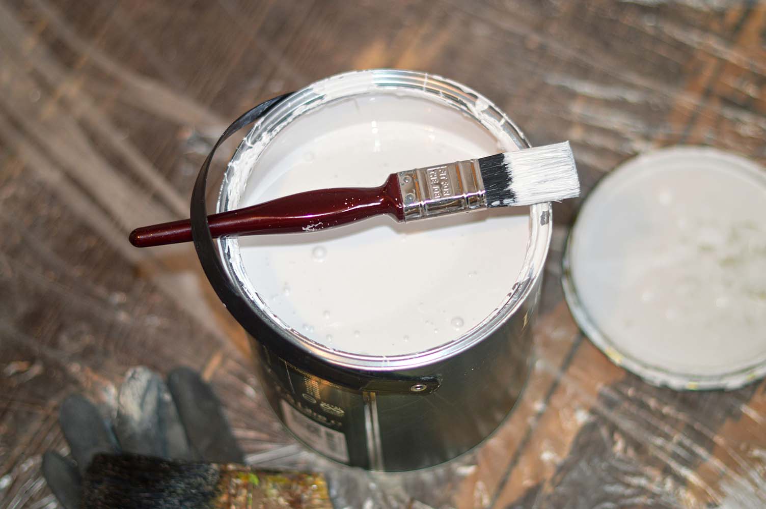 A paint tin and brush